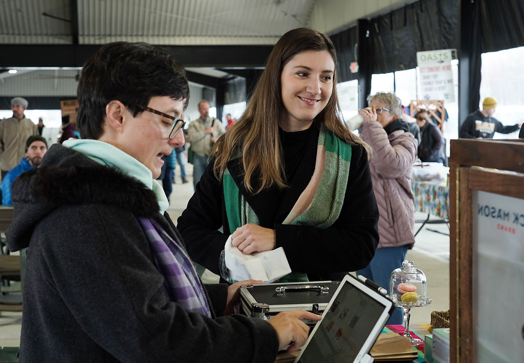 Julie Hutton smiles as Amber Rodgers checks a customer out